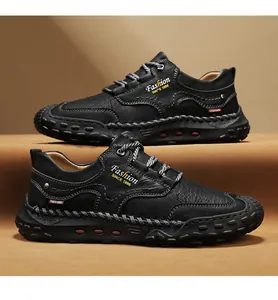 Detail view of black leather loafers showing contrast stitching and embossed fashion text