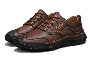 Detailed view of brown leather loafers featuring hand-stitched seams and rubber outsoles