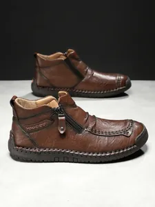 Detail of brown vintage leather boot with side zipper and thick rubber sole