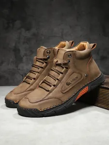 Close-up of brown leather boots with handmade stitching and durable rubber sole