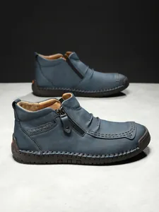 Detail view of leather stitching and side zipper on men's casual outdoor leather boots