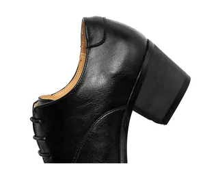 Detailed side view of black embroidered cuban shoes featuring a sturdy block heel and leather texture