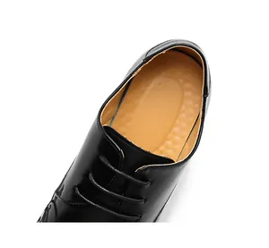 Detailed close-up of men's leather dress shoe with black laces and brown lining