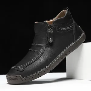 Mens black leather boots with side zipper and contrast stitching on a rubber sole