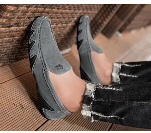 Détail de mocassins en daim gris avec logo kangourou gaufré et une semelle plate flexible