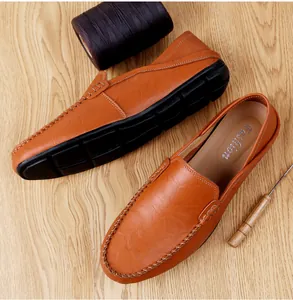 Detail of brown pebbled leather loafers with hand-stitched seams and non-slip soles