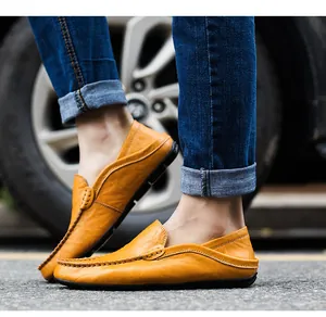 Close-up of tan leather loafers for men featuring hand-stitched moc-toe details