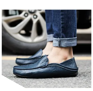 Outdoor shot of dark blue leather loafers with side stitching and soft rubber soles