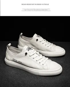 Detail of white leather men's sneakers with SOCIAL MAN text and thick rubber sole