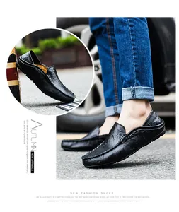 Close-up of black genuine leather loafers showing detailed grain texture and fine hand stitching