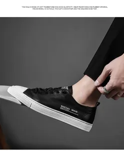 Detail shot of black leather casual shoes with white rubber sole and Social Man lettering