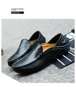 Detail shot of black leather loafers showing natural grain and handmade stitching on sole