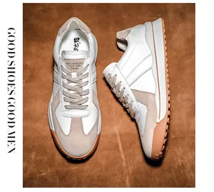 Detailed close-up showing white leather and beige suede textures of the casual retro sneakers