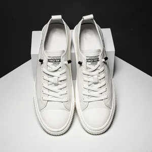 White leather casual men's sneakers with lace-up design and non-slip sole in top view