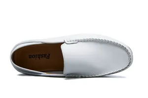 Close-up of white leather loafers featuring moccasin stitching and soft inner sole