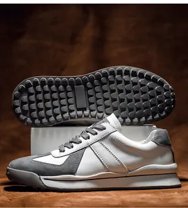 Detail of retro German army sneakers showing non-slip rubber sole and white leather upper