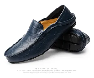 Macro shot of navy leather loafers showing hand-stitched seams and rubber pebble soles