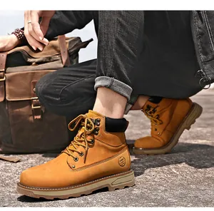 Detailed outdoor shot of men's wheat nubuck leather work boots with sport logo engraving