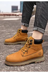 Outdoor macro shot of yellow leather work boots with sport logo and rugged sole
