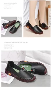 Detail of black loafers showing manual stitching and red apple motif on the sole