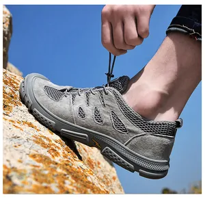 Nahaufnahme der schnelltrocknenden Herren-Wanderschuhe mit Mesh auf Felsen