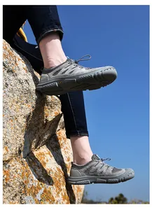 Detail von grauen atmungsaktiven Outdoor-Wasserschuhen auf Felsen zum Wandern und Angeln