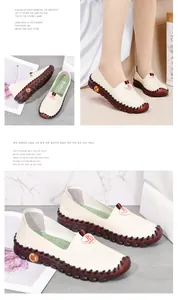 Detail of off-white casual flats showing red-brown thick rubber sole and strawberry motif