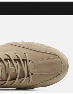 Detail of khaki suede men's casual boot showing double-row stitching and lace-up design