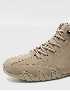 Close-up of khaki suede high-top boots featuring premium stitching and anti-slip rubber soles