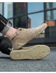 Detailed low angle shot of khaki suede high-top casual boots with anti-slip rubber soles