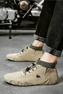 Detail view of men's khaki suede boots with green knit collar and toggle lacing system