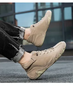 Outdoor low angle shot of khaki suede high-top casual boots with anti-slip rubber soles