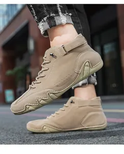 Detail of khaki high-top men's shoes with velcro strap and durable rubber sole