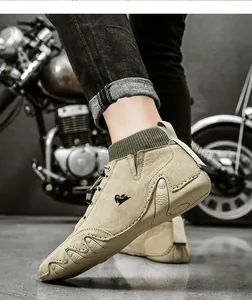 Detail of khaki suede boots with knitted ankle collar and non-slip wavy rubber sole
