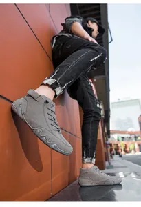 Detailed view of grey high-top men's casual boots with durable non-slip wavy soles