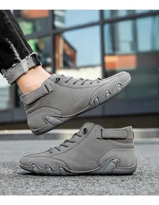 Detail of dark grey high-top casual sneakers with decorative stitching and velcro straps