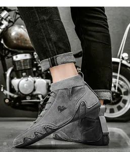 Close-up of grey high-top boots with knit collar and unique wavy anti-slip soles