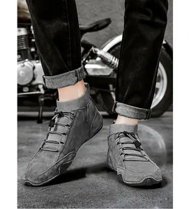 Close-up of men's grey suede high-top boots with knit sock collar and elastic laces