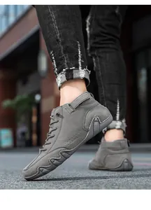 Macro shot of grey suede high-top casual boots with textured non-slip rubber soles