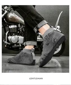 Gray suede mid-top boots with knit sock collar and rugged rubber sole on a vintage bike