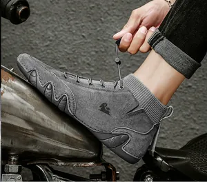 Close-up of gray suede outdoor boot with sheep logo and elastic knit sock cuff