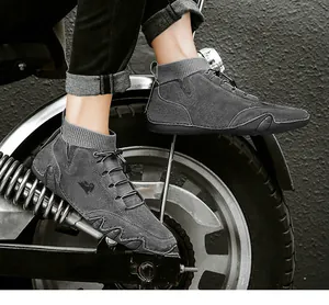 Detail of grey suede mid-top sneakers with knit collar and wave-patterned slip-resistant sole