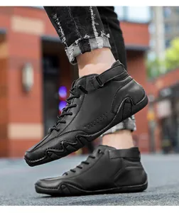 Outdoor shot of black high-top casual men's shoes with textured leather and wavy sole details