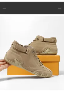 Close-up of khaki suede mid-top boots with laces and hook-and-loop strap design