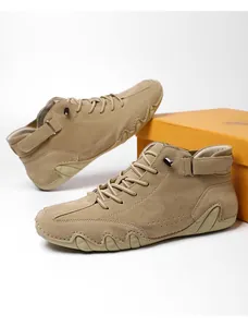 Close-up of khaki suede high-top boots featuring a unique wavy gum sole and Velcro strap