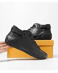 Detail of black mid-top casual shoes showing flexible anti-slip sole and pebbled leather texture