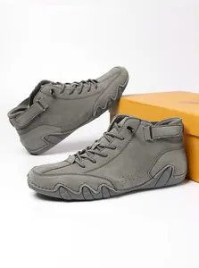 Detail of dark grey suede outdoor shoes with anti-slip rubber soles and velcro straps