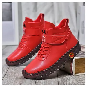 Detail of red winter boots showing warm plush lining and woven stitching on rubber sole
