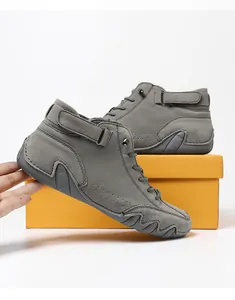 Detail of grey suede high-top casual boots featuring lace-up design and ankle strap