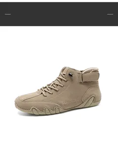 Detail of khaki high-top casual boots with cross laces and ankle velcro strap design